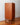 Sideview detail of mid century modern chest of drawers by G Plan furniture with sleigh-base
