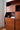 Angled sculptural silhouette of teak veneer wall unit